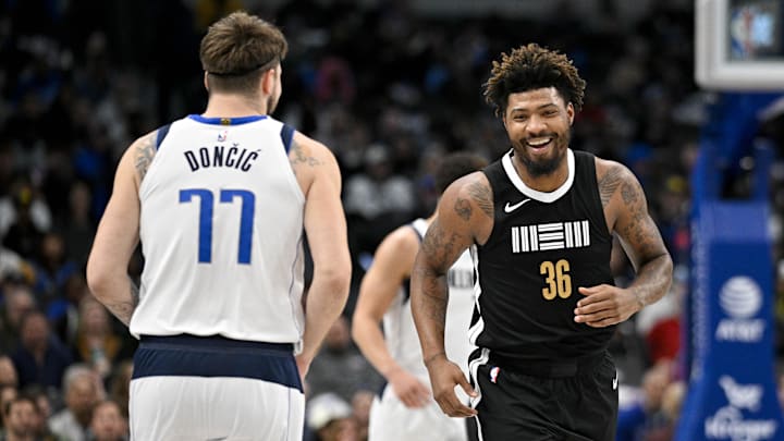 Jan 9, 2024; Dallas, Texas, USA; Memphis Grizzlies guard Marcus Smart (36) smiles after scoring against Dallas Mavericks guard Luka Doncic (77) during the first quarter at the American Airlines Center. Mandatory Credit: Jerome Miron-Imagn Images