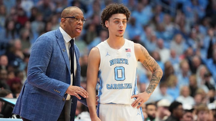 Feb 28, 2026; Chapel Hill, North Carolina, USA; North Carolina Tar Heels head coach Hubert Davis with guard Kyan Evans (0) in the second half at Dean E. Smith Center. Mandatory Credit: Bob Donnan-Imagn Images