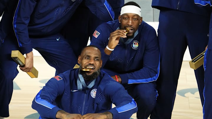 Aug 10, 2024; Paris, France; United States guard LeBron James (6) and centre Bam Adebayo (13) celebrate with their gold medals after defeating France in the men's basketball gold medal game during the Paris 2024 Olympic Summer Games at Accor Arena. Mandatory Credit: Rob Schumacher-Imagn Images