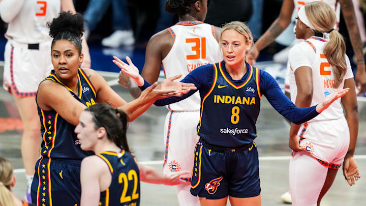 Indiana Fever forward Damiris Dantas (12) and Indiana Fever guard Sophie Cunningham (8) react to the action Tuesday, June 17, 2025, during a game between the Indiana Fever and the Connecticut Sun at Gainbridge Fieldhouse in Indianapolis.