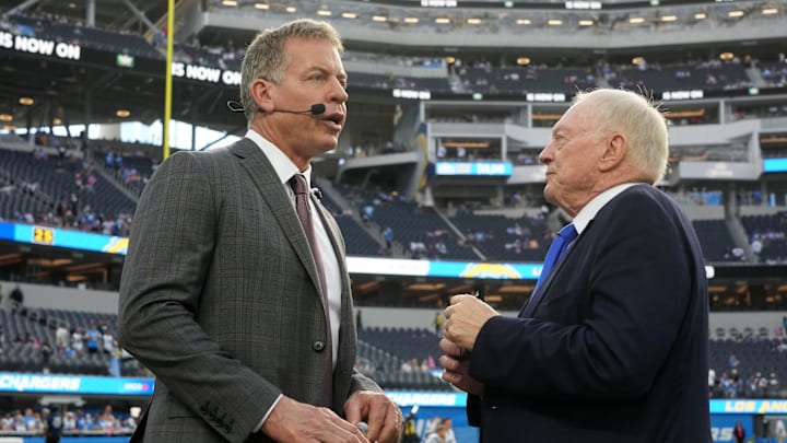 Dallas Cowboys owner Jerry Jones talks with former quarterback Troy Aikman before a game against the Los Angeles Chargers