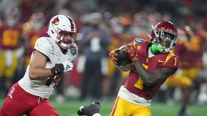 Dec 27, 2023; San Diego, CA, USA; Southern California Trojans wide receiver Zachariah Branch (1) catches the ball against Louisville Cardinals defensive lineman Stephen Herron (14) in the first half of the Holiday Bowl at Petco Park. Mandatory Credit: Kirby Lee-Imagn Images