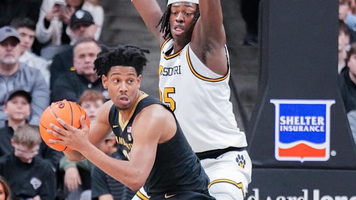 Jan 11, 2025; Columbia, Missouri, USA;Vanderbilt Commodores guard AJ Hoggard (11) looks to pass as Missouri Tigers guard Mark Mitchell (25) defends during the first half at Mizzou Arena. Mandatory Credit: Denny Medley-Imagn Images