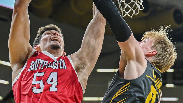Nov 12, 2024; Iowa City, Iowa, USA; South Dakota Coyotes center Cameron Fens (54) shoots against Iowa Hawkeyes forward Even Brauns (0) during the first half at Carver-Hawkeye Arena. Mandatory Credit: Jeffrey Becker-Imagn Images Nov 12, 2024; Iowa City, Iowa, USA; South Dakota Coyotes center Cameron Fens (54) shoots against Iowa Hawkeyes forward Even Brauns (0) during the first half at Carver-Hawkeye Arena. Mandatory Credit: Jeffrey Becker-Imagn Images