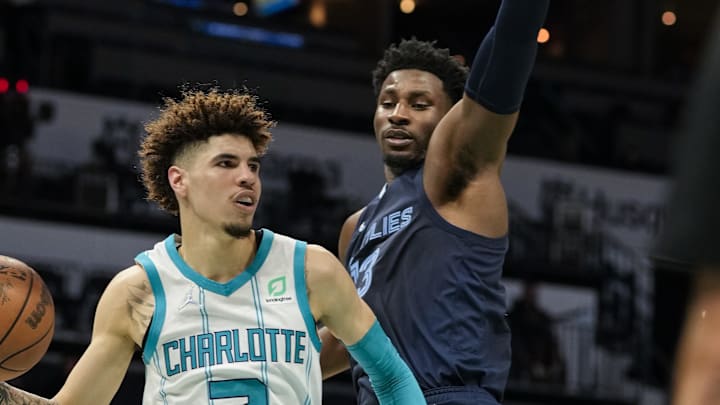 Oct 7, 2021; Charlotte, North Carolina, USA; Charlotte Hornets guard LaMelo Ball (2) dishes off covered by Memphis Grizzlies forward Jaren Jackson Jr. (13) during the second quarter at Spectrum Center. Mandatory Credit: Jim Dedmon-Imagn Images Oct 7, 2021; Charlotte, North Carolina, USA; Charlotte Hornets guard LaMelo Ball (2) dishes off covered by Memphis Grizzlies forward Jaren Jackson Jr. (13) during the second quarter at Spectrum Center. Mandatory Credit: Jim Dedmon-Imagn Images