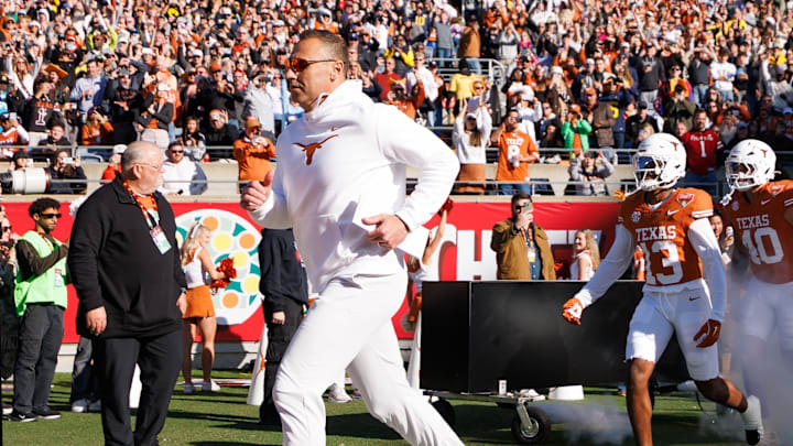 Texas Longhorns head coach Steve Sarkisian runs onto the field before a game against the Michigan Wolverines.