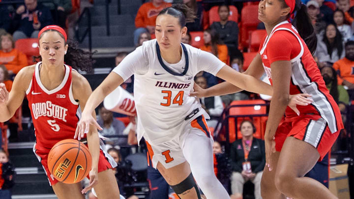 Illinois guard Maddie Webber (34) knifes between two Ohio State defenders in the Illini's 78-69 loss to the Buckeyes on Wednesday at the State Farm Center in Champaign, Illinois.