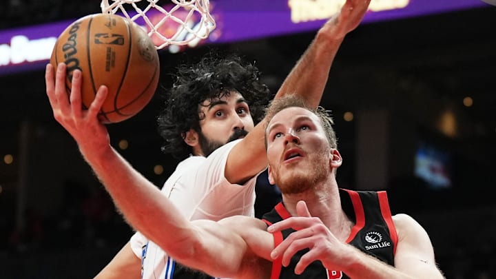 Toronto Raptors center Jakob Poeltl (19) drives to the basket against Orlando Magic center Goga Bitadze (35) during the third quarter at Scotiabank Arena.
