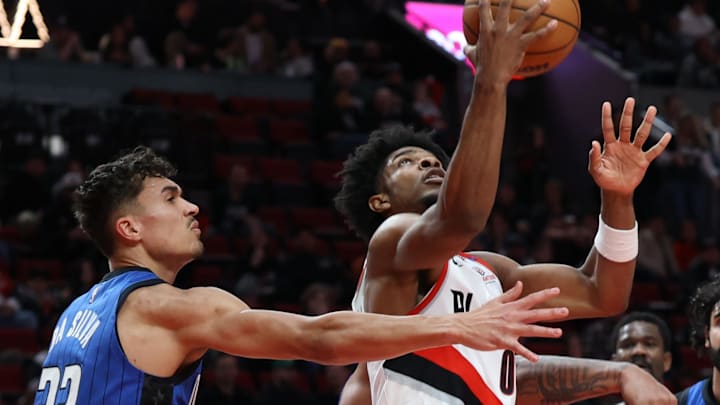 Portland Trail Blazers guard Scoot Henderson (00) shoots agaisnt Orlando Magic forward Tristan da Silva (23) in the first half at Moda Center.