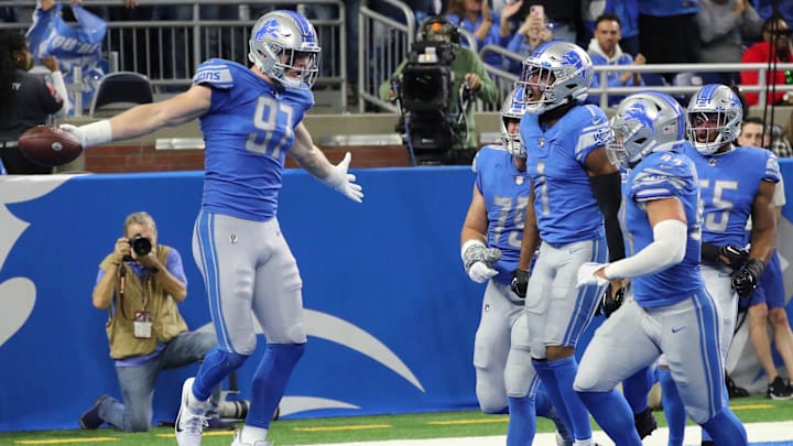 Detroit Lions defensive end Aidan Hutchinson (97) celebrates his interception against the Green Bay