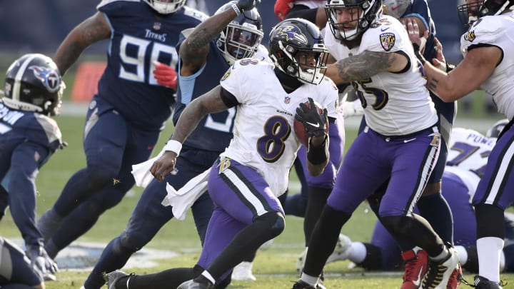 Jan 10, 2021; Nashville, Tennessee, USA; Baltimore Ravens quarterback Lamar Jackson (8) picks up a first down during the Tennessee Titans game against the Baltimore Ravens. Mandatory Credit: George Walker/The Tennessean via USA TODAY Sports