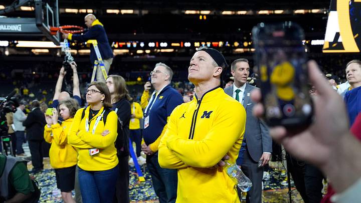 Michigan head coach Dusty May watches the Jumbotron during the NCAA national championship trophy after the team beat Connecticut at Lucas Oil Stadium in Indianapolis on Monday, April 6, 2026.