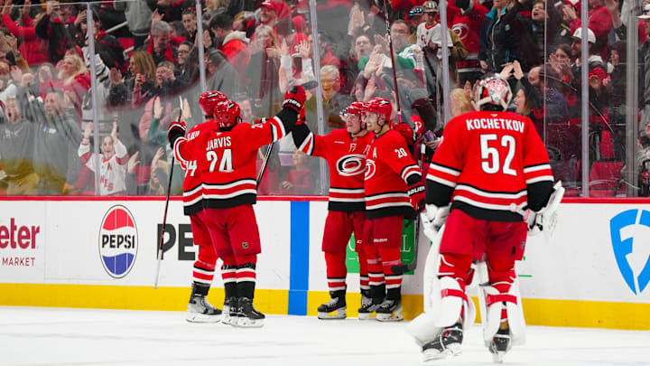 Mar 2, 2025; Raleigh, North Carolina, USA;  Carolina Hurricanes center Sebastian Aho (20) celebrates his game winning goal with right wing Jackson Blake (53), center Seth Jarvis (24), and  defenseman Jaccob Slavin (74) in the overtime against the Calgary Flames at Lenovo Center. Mandatory Credit: James Guillory-Imagn Images