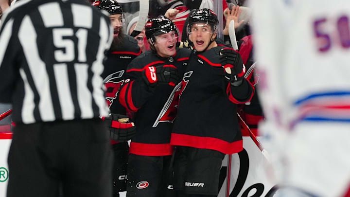 Nov 27, 2024; Raleigh, North Carolina, USA;  Carolina Hurricanes right wing Jackson Blake (53) is congratulated by defenseman Brent Burns (8) and center Jack Drury (18) after his goal against the New York Rangers during the third period at Lenovo Center. Mandatory Credit: James Guillory-Imagn Images