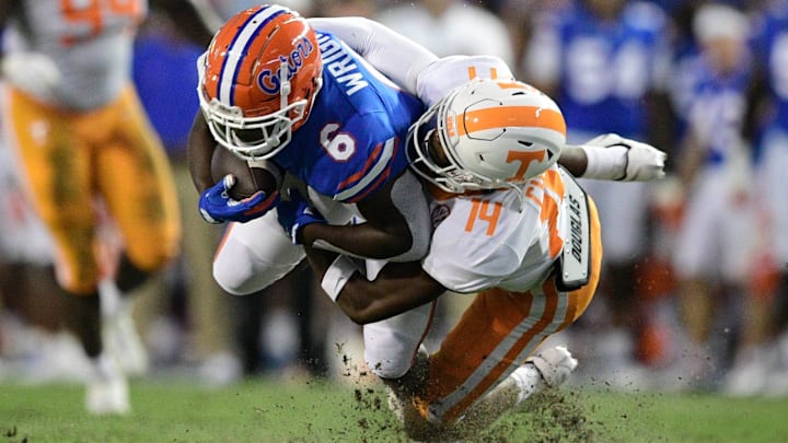 Tennessee defensive back Christian Charles (14) tackles Florida running back Nay'Quan Wright (6)  during the first quarter of an NCAA football game against Florida at Ben Hill Griffin Stadium in Gainesville, Florida on Saturday, Sept. 25, 2021.

Tennflorida0925 0802
