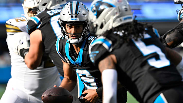 Nov 9, 2025; Charlotte, North Carolina, USA; Carolina Panthers quarterback Bryce Young (9) fakes a handoff to running back Rico Dowdle (5) in the third quarter at Bank of America Stadium.