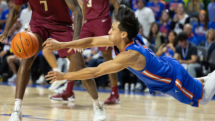 Florida guard Xaivian Lee (1) passes as he tripps against Florida State during the second half of an NCAA men's basketball game at Exactec Arena at the Steven C. O Connell Center in Gainesville, FL. Florida guard Xaivian Lee (1) passes as he tripps against Florida State during the second half of an NCAA men's basketball game at Exactec Arena at the Steven C. O Connell Center in Gainesville, FL.