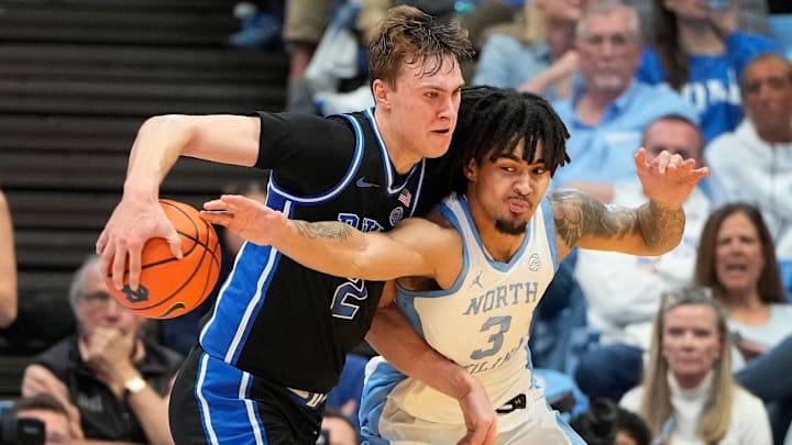 Duke Blue Devils forward Cooper Flagg (2) with the ball as North Carolina Tar Heels guard Elliot Cadeau (3)