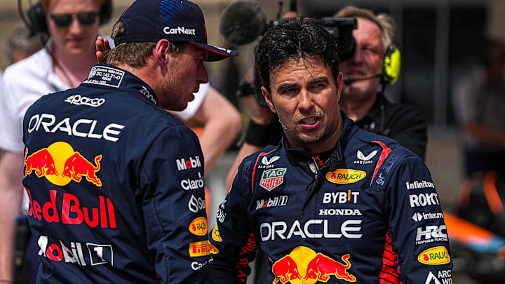 Oracle Red Bull Racing driver Max Verstappen, left, talks to Sergio Perez, right, after the Sprint