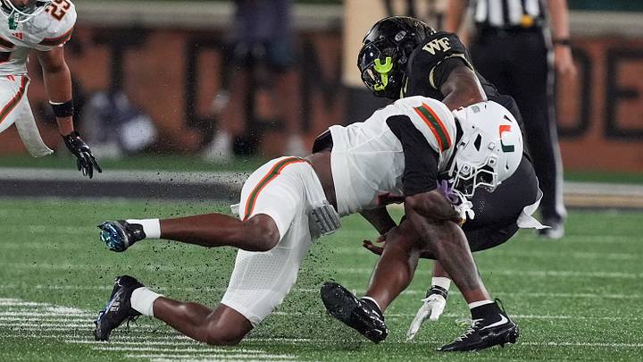 Sep 18, 2026; Winston-Salem, North Carolina, USA;  Miami (FL) Hurricanes safety Zechariah Poyser (7) tackles Wake Forest Demon Deacons tight end Kamrean Johnson (12) during the first half at Allegacy Federal Credit Union Stadium.  Mandatory Credit: Jim Dedmon-Imagn Images