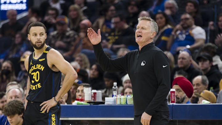 Dec 30, 2024; San Francisco, California, USA; Golden State Warriors guard Stephen Curry (30) watches as head coach Steve Kerr reacts during the first quarter of the game against the Cleveland Cavaliers against the Cleveland Cavaliers at Chase Center. Mandatory Credit: John Hefti-Imagn Images Dec 30, 2024; San Francisco, California, USA; Golden State Warriors guard Stephen Curry (30) watches as head coach Steve Kerr reacts during the first quarter of the game against the Cleveland Cavaliers against the Cleveland Cavaliers at Chase Center. Mandatory Credit: John Hefti-Imagn Images