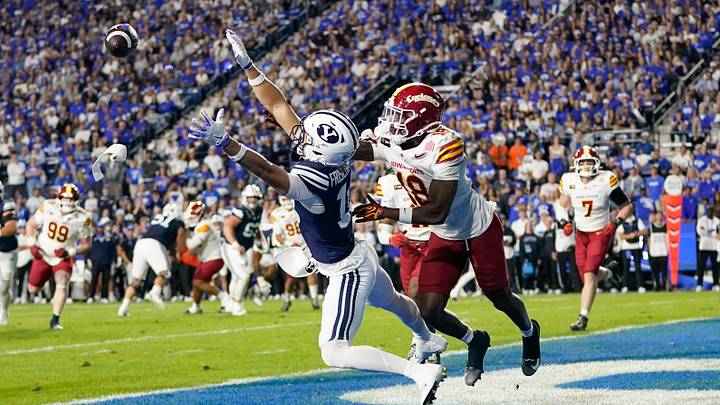 Oct 9, 2026; Provo, Utah, USA;  BYU Cougars wide reciever Reggie Frischknecht (18) dives for a ball while being defended by Iowa State Cyclones cornerback David Coffey (18) during the first half at LaVell Edwards Stadium.  Mandatory Credit: Aaron Baker-Imagn Images
