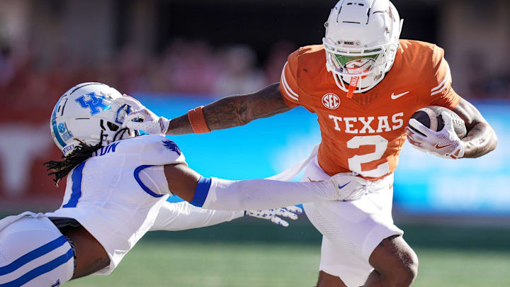 Texas Longhorns wide receiver Matthew Golden stiff arms Kentucky Wildcats defensive back Maxwell Hairston.