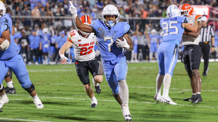 Nov 11, 2023; Orlando, Florida, USA; UCF Knights running back RJ Harvey (7) carries the ball for a touchdown during the second half against the Oklahoma State Cowboys at FBC Mortgage Stadium. Mandatory Credit: Mike Watters-USA TODAY Sports