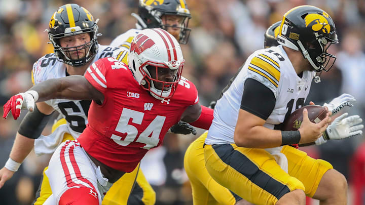 Wisconsin linebacker Jordan Turner (54) sacks Iowa quarterback Deacon Hill (10) on Saturday, October 14, 2023, at Camp Randall Stadium in Madison, Wis. 