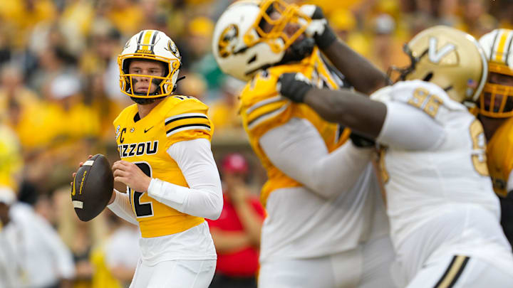Sep 21, 2024; Columbia, Missouri, USA; Missouri Tigers quarterback Brady Cook (12) drops back to pass during the first half against the Vanderbilt Commodores at Faurot Field at Memorial Stadium. Mandatory Credit: Jay Biggerstaff-Imagn Images Sep 21, 2024; Columbia, Missouri, USA; Missouri Tigers quarterback Brady Cook (12) drops back to pass during the first half against the Vanderbilt Commodores at Faurot Field at Memorial Stadium. Mandatory Credit: Jay Biggerstaff-Imagn Images