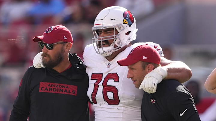 Oct 6, 2024; Santa Clara, California, USA; Arizona Cardinals guard Will Hernandez (76) is helped off of the field by medical personnel after suffering an injury during the fourth quarter against the San Francisco 49ers at Levi's Stadium. Mandatory Credit: Darren Yamashita-Imagn Images Oct 6, 2024; Santa Clara, California, USA; Arizona Cardinals guard Will Hernandez (76) is helped off of the field by medical personnel after suffering an injury during the fourth quarter against the San Francisco 49ers at Levi's Stadium. Mandatory Credit: Darren Yamashita-Imagn Images