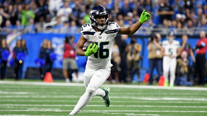 Sep 30, 2024; Detroit, Michigan, USA; Seattle Seahawks wide receiver Tyler Lockett (16) runs the ball against the Detroit Lions in the third quarter at Ford Field. Mandatory Credit: Eamon Horwedel-Imagn Images