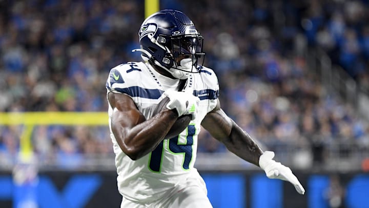 Sep 30, 2024; Detroit, Michigan, USA; Seattle Seahawks wide receiver DK Metcalf (14) runs with the ball against the Detroit Lions in the second quarter at Ford Field.