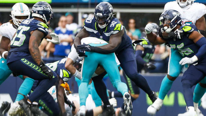 Seattle Seahawks defensive tackle Jarran Reed (90) sacks Miami Dolphins quarterback Tim Boyle (14) during the fourth quarter at Lumen Field.