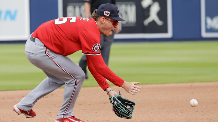 Feb 22, 2025; West Palm Beach, Florida, USA; Washington Nationals infielder Brady House fields a ground ball in the fourth inning against the Houston Astros at CACTI Park of the Palm Beaches. 