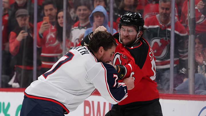 Blue Jackets defenseman Brendan Smith fights New Jersey Devils forward Paul Cotter