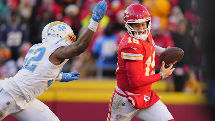 Dec 14, 2025; Kansas City, Missouri, USA; Kansas City Chiefs quarterback Patrick Mahomes (15) scrambles against Los Angeles Chargers linebacker Khalil Mack (52) during the second half at GEHA Field at Arrowhead Stadium. Mandatory Credit: Jay Biggerstaff-Imagn Images