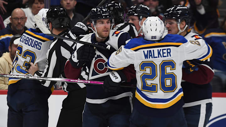 Jan 31, 2025; Denver, Colorado, USA; Colorado Avalanche defenseman Devon Toews (7) St. Louis Blues left wing Nathan Walker (26) and other players have to be separated after the whistle during the first period at Ball Arena. Mandatory Credit: Christopher Hanewinckel-Imagn Images