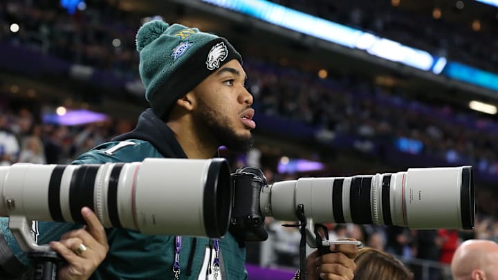 Feb 4, 2018; Minneapolis, MN, USA; Minnesota Timberwolves center Karl-Anthony Towns captures images while on the sidelines during the Philadelphia Eagles playing against the New England Patriots in Super Bowl LII at U.S. Bank Stadium. Mandatory Credit: Matthew Emmons-Imagn Images
