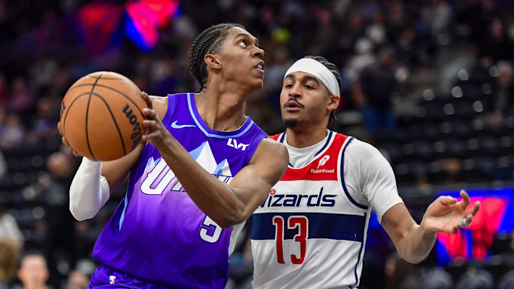 Mar 19, 2025; Salt Lake City, Utah, USA; Utah Jazz forward Cody Williams (5) makes layup against Washington Wizards guard Jordan Poole (13) during the second half at the Delta Center. Mandatory Credit: Peter Creveling-Imagn Images Mar 19, 2025; Salt Lake City, Utah, USA; Utah Jazz forward Cody Williams (5) makes layup against Washington Wizards guard Jordan Poole (13) during the second half at the Delta Center. Mandatory Credit: Peter Creveling-Imagn Images