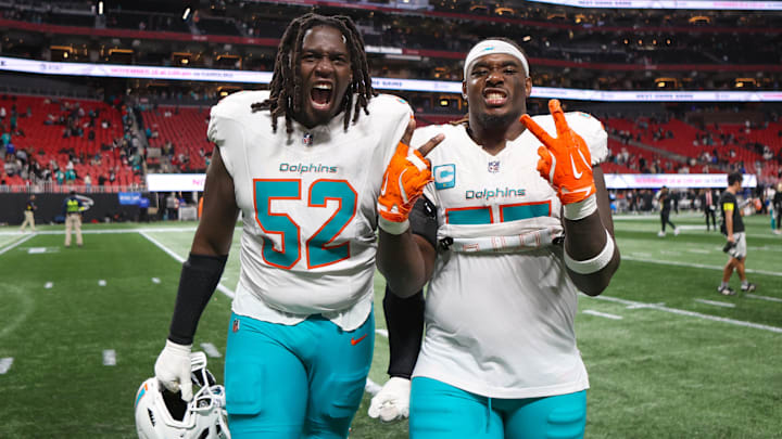 Miami Dolphins offensive tackle Patrick Paul (52) and center Aaron Brewer (55) celebrate after a victory over the Atlanta Falcons at Mercedes-Benz Stadium in the 2025 season.