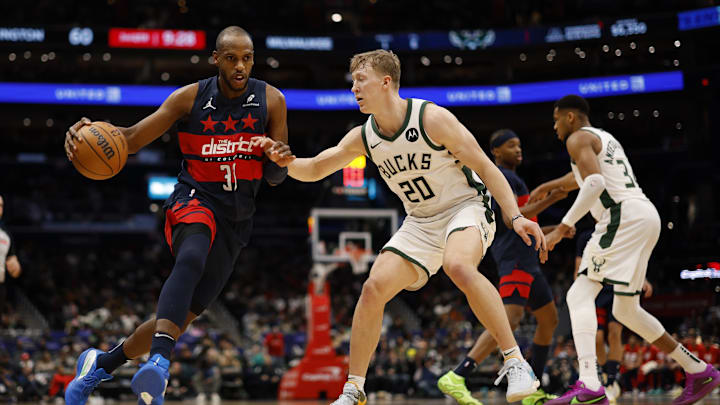 Feb 21, 2025; Washington, District of Columbia, USA; Washington Wizards forward Khris Middleton (32) drives to the basket as Milwaukee Bucks guard AJ Green (20) defends in the second half at Capital One Arena. Mandatory Credit: Geoff Burke-Imagn Images