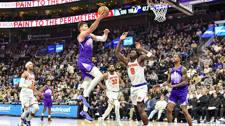 Nov 23, 2024; Salt Lake City, Utah, USA; Utah Jazz center Walker Kessler (24) takes a layup over New York Knicks forward/guard OG Anunoby (8) during the second half at the Delta Center. Mandatory Credit: Christopher Creveling-Imagn Images