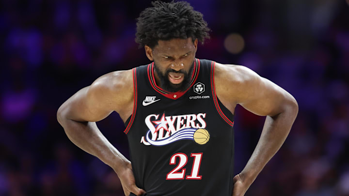 Feb 26, 2026; Philadelphia, Pennsylvania, USA; Philadelphia 76ers center Joel Embiid (21) reacts while clutching his body after a play against the Miami Heat during the second quarter at Xfinity Mobile Arena. Mandatory Credit: Bill Streicher-Imagn Images