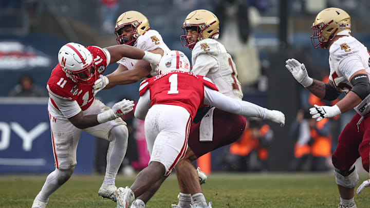 Dec 28, 2024; Bronx, NY, USA; Boston College Eagles quarterback Grayson James (14) is sacked by Nebraska Cornhuskers defensive lineman Vincent Shavers (1) during the first half at Yankee Stadium. 