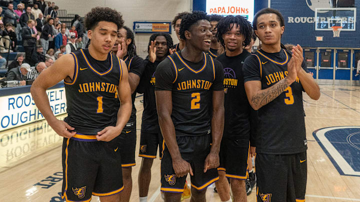 Members of the Johnston boys basketball team celebrate a win over Des Moines Roosevelt during a high school boys substate final basketball game on Tuesday, March, 3, at Des Moines Roosevelt High School. Mandatory Credit: Bryon Houlgrave-The Des Moines Register
