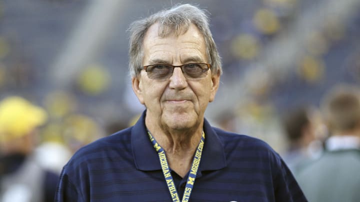 Oct 7, 2017; Ann Arbor, MI, USA; Michigan Wolverines former head coach Lloyd Carr stands on the field prior to a game against the Michigan State Spartans at Michigan Stadium. Oct 7, 2017; Ann Arbor, MI, USA; Michigan Wolverines former head coach Lloyd Carr stands on the field prior to a game against the Michigan State Spartans at Michigan Stadium.