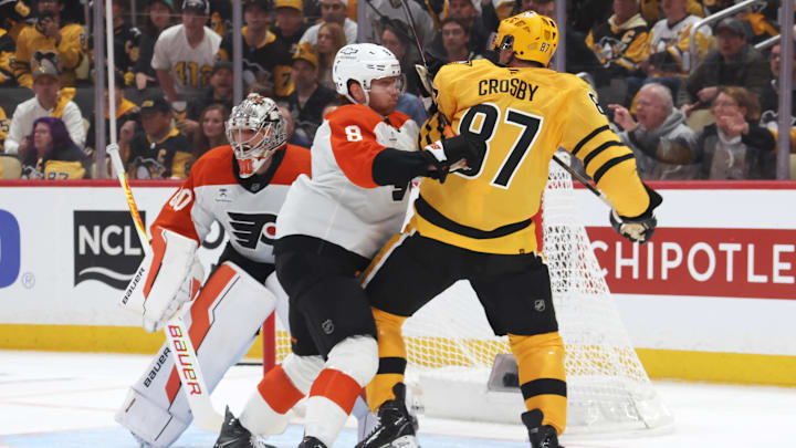 Apr 18, 2026; Pittsburgh, Pennsylvania, USA; Philadelphia Flyers defenseman Cam York (8) checks Pittsburgh Penguins center Sidney Crosby (87) in front of Flyers goaltender Dan Vladar (80) during the first period against in game one of the first round of the 2026 Stanley Cup Playoffs at PPG Paints Arena.