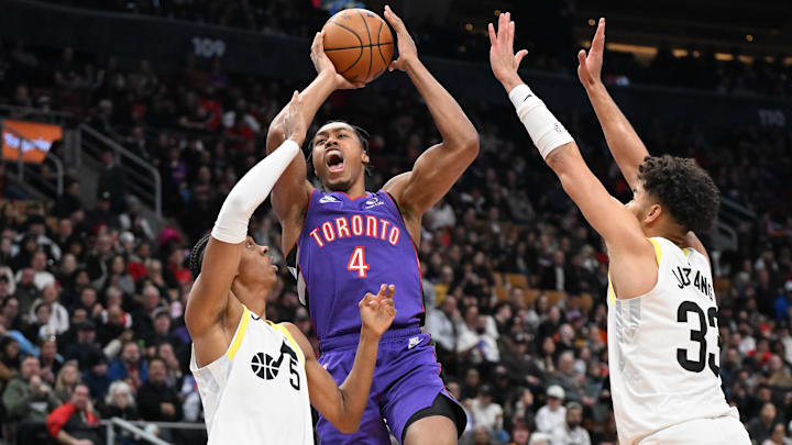 Mar 7, 2025; Toronto, Ontario, CAN; Toronto Raptors forward Scottie Barnes (4) drives to the basket between Utah Jazz forward Cody Williams (5) and guard Johnny Juzang (33) in the first half at Scotiabank Arena. Mandatory Credit: Dan Hamilton-Imagn Images
