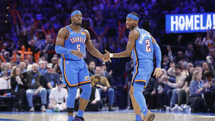 Feb 12, 2025; Oklahoma City, Oklahoma, USA; Oklahoma City Thunder guard Luguentz Dort (5) and guard Shai Gilgeous-Alexander (2) celebrate after a play against the Miami Heat during the second half at Paycom Center. Mandatory Credit: Alonzo Adams-Imagn Images